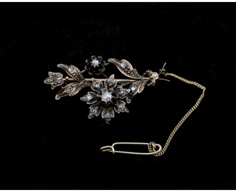 A 14 karat gold brooch set with rose cut diamond. ca. 1920. The ring is made in a flower shape and set with rose cut diamond.