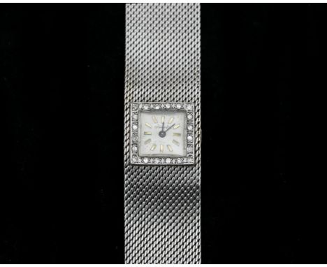 A 14 karat white gold ladies wristwatch Chronos. Approx. 1970. Manual wind, A rectangular case surrounded by a brilliant cut 