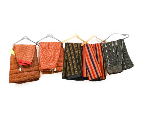 Three Late Victorian Striped Wool Underskirts, with cream and glazed black cotton linings; Two Printed Cotton Padded Underski