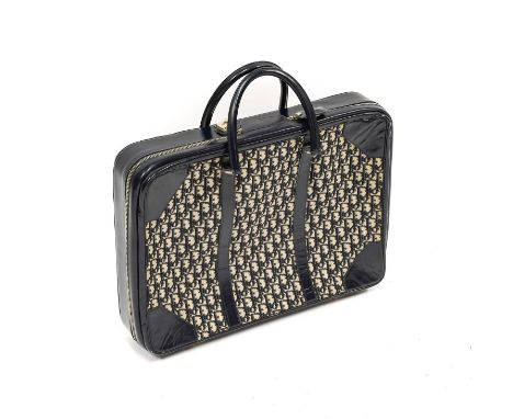 Circa 1970s Blue Christian Dior Monogrammed Small Suitcase with blue leather mounts, zipped fastening, two carrying handles, 