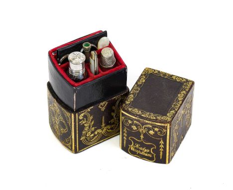 A Mid 19th Century 'Lady's Companion' Set, in a gilt tooled decorated brown leather book form etui, the cherry velvet fitted 