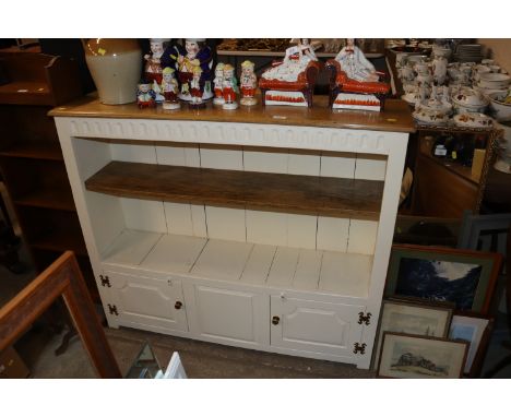 A part painted oak bookcase fitted single shelf and cupboard to base 