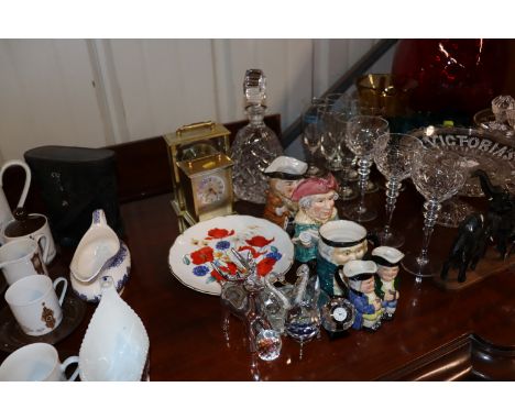 A quantity of Toby style jugs, Leonardo timepiece, various ornaments, mantel clock, decanter with stopper