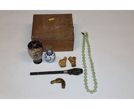 A box containing snuff bottle; jade beads;&nbsp; two umbrella handles etc