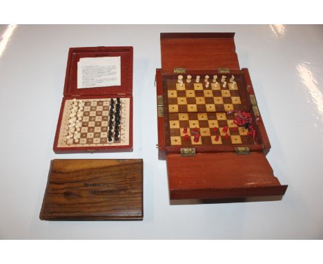 A K & C travelling chess set; a wooden folding travelling chess set with various bone and plastic pieces and a Jerusalem oliv