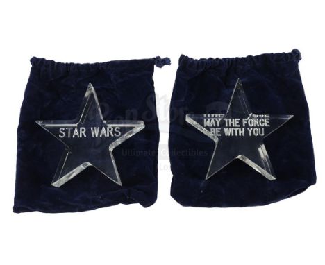 A pair of acrylic star crew gifts and bags from the production of George Lucas' Star Wars: A New Hope. Engraved stars were gi