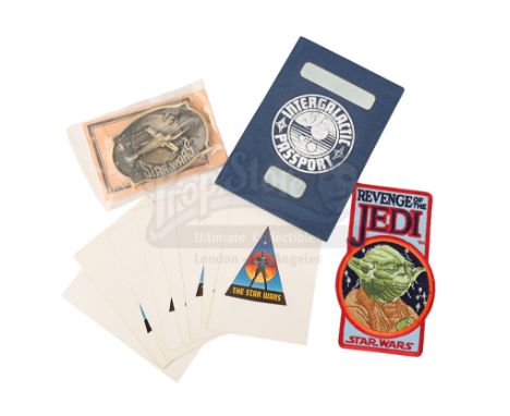 An intergalactic passport crew gift, a brass belt buckle, an embroidered patch and a set of stickers from the productions of 