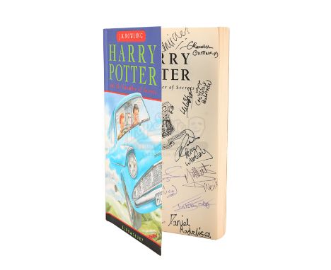 A cast-autographed paperback copy of J.K. Rowling's novel Harry Potter and the Chamber of Secrets. Published by Bloomsbury, t