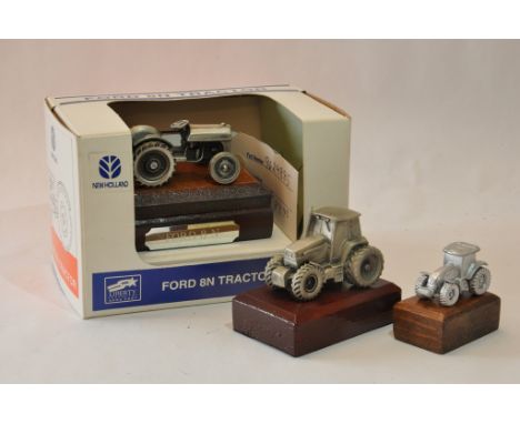 Pewter finish tractor group including Ford and New Holland issues. (3)