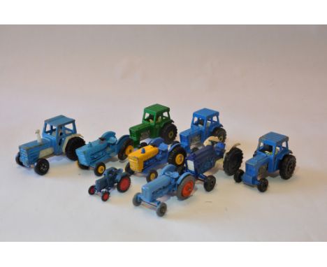 Group of small scale tractors from various makers including Matchbox. (9)