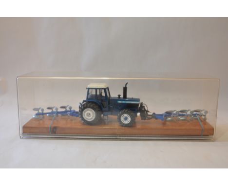 Bespoke Presentation piece comprising Britains Ford TW30 Tractor with Front and Rear Mounted Ploughs. 