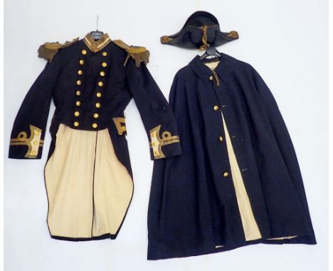 A 19th century Naval officers uniform including bicorn hat, dress coat with epaulettes and a cape 