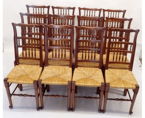 A set of twelve rush seated ladder back country style dining chairs 