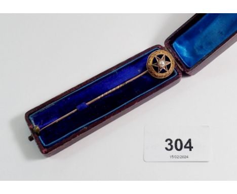 A Victorian yellow metal stick pin with blue enamel and pearl star, cased 