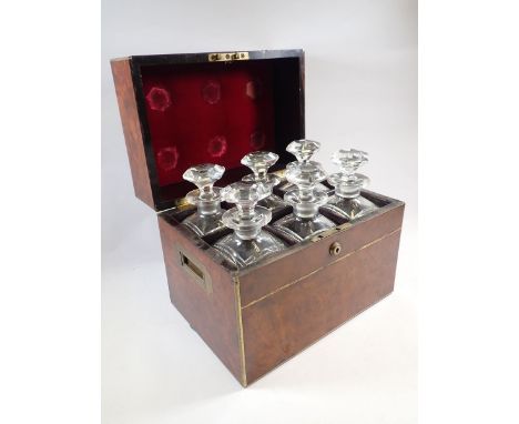 A Victorian Sampson &amp; Mordan walnut and brass bound decanter box containing six matching decanters lock plate stamped 'S 