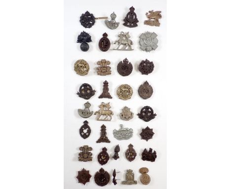 A collection of 30 WWII plastic economy head dress badges, The Buffs, Glosters, The Welsh, Royal Welsh Fusileers, Durham Ligh