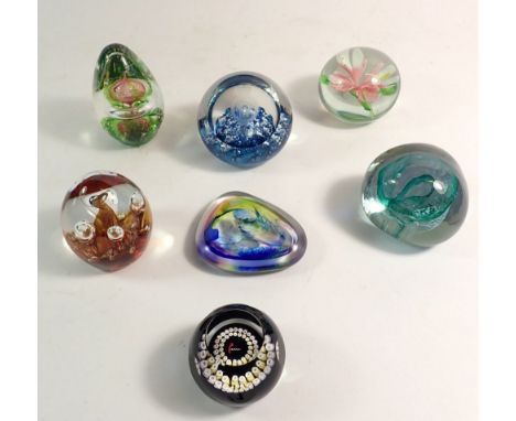 A collection of seven glass paperweights including Caithness and Selkirk 