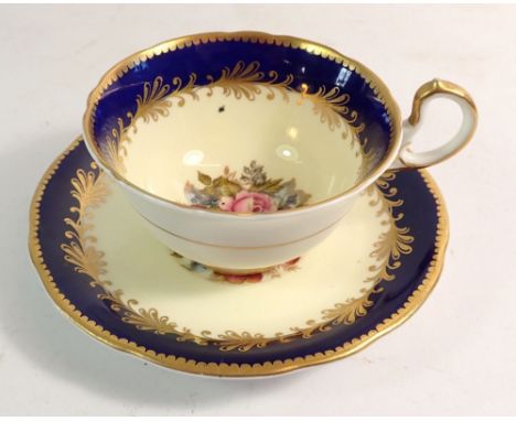 An Ainsley cabinet cup and saucer painted flowers and signed R Bailey 