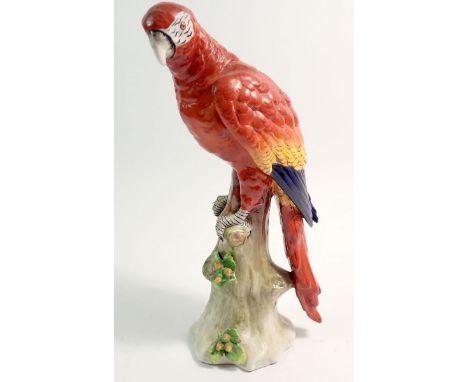 A Sitzendorf porcelain parrot on tree trunk, 24cm 