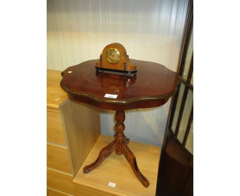 A Small Clock and a Pedestal Table 