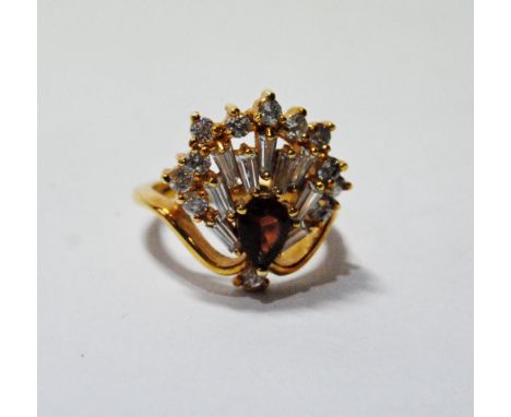 Dress ring with a hessonite garnet with a fan of baguette and brilliant white sapphires, in gold, '14K'. Condition Report Siz