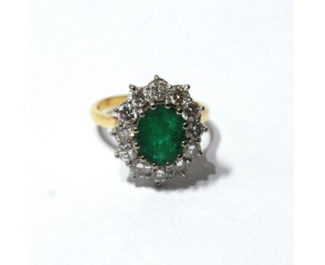 Diamond and emerald cluster ring with twelve brilliants, each approximately .1ct, '18ct'. Condition Report Size N