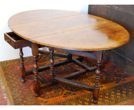 Titchmarsh & Goodwin style 20th century oak oval gate-leg table fitted with a drawer.