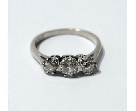 Diamond three-stone ring with brilliants approximately .15ct and .3ct, 'plat'. Condition Report Size L½