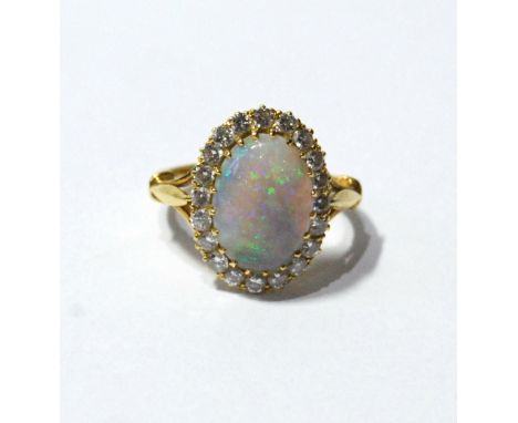 Diamond and opal cluster ring with twenty brilliants, in 18ct gold. Condition Report Size O½.  Opal has a chip next to claw (