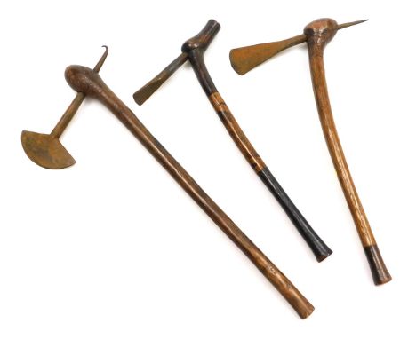 Three African tribal war axes, possibly Chokwe, with steel axe heads and natural wooden shafts, two with burnt decoration, 57