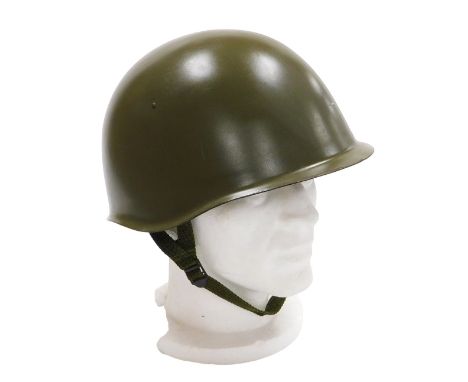 A Czechoslovakian Army steel helmet, circa 1960 with inner leather liner and chin strap. 