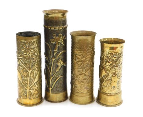 A WWI brass ordnance shell cases, each with trench art decoration, of ivy and floral designs, the tallest 30cm. 