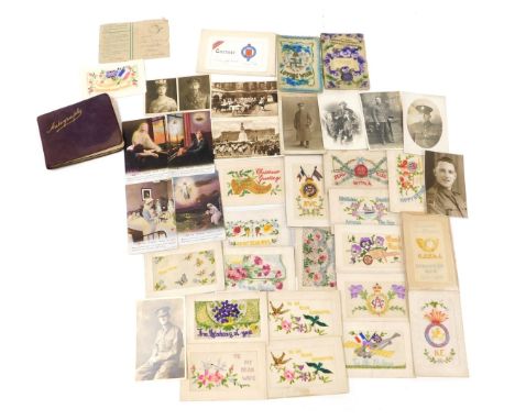 A collection of First World War silk postcards and others, including photographic portrait postcards of WWI soldiers and othe