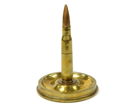 A WWII brass ordnance table lighter, in the form of a shell case lighter, mounted on a twenty-five pound artillery brass shel