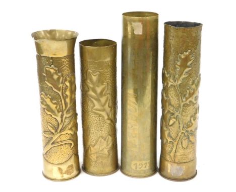 Four WWI brass ordnance shell cases, all with trench art decoration, including one inscribed Verdun, 1917, and three with emb