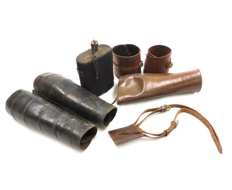 A British Army WWI water bottle, with felt cover, leather gaiters, officer's leather bayonet frog, etc. 