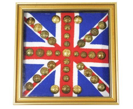 Various British Army regimental brass buttons, mounted on Union Jack felt flag backing, framed and glazed. 