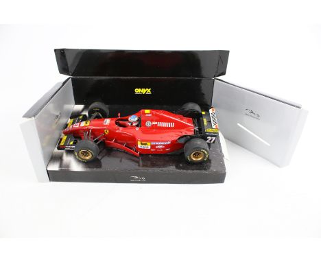 A TFBB (Toys for Big Boys) remote control Porsche and an Onyx Formula 1 model. The Onyx 1:18 scale and a Ferrari 412T2, both 