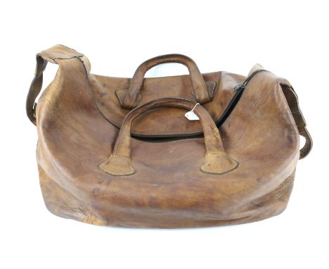A large vintage brown leather bag. With twin handles, an adjustable shoulder strap and a zip, L74cm