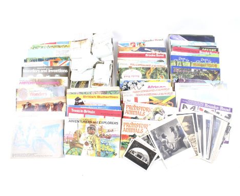 An assortment of vintage postcards and collectors cards. Some contained within albums, the cards including 'Olympic Greats', 