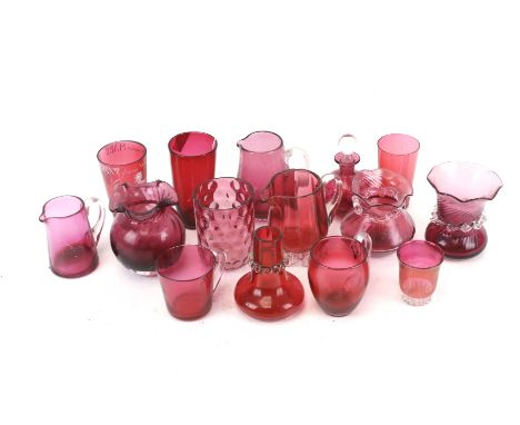 Collection of assorted cranberry glass items. Including beakers, jugs and an enamel 'A present from Weston Super Mare', etc. 