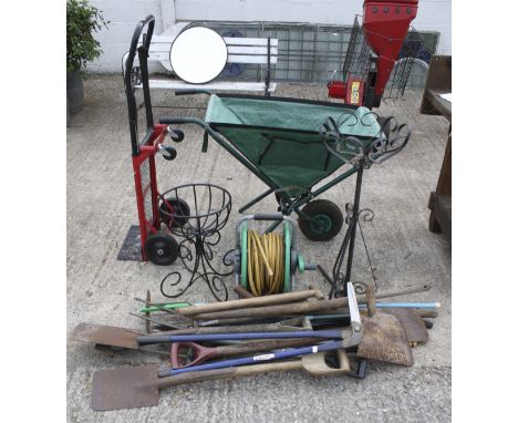 A collection of assorted vintage garden hand tools. including a folding wheel barrow, a sack truck and a hose, etc.