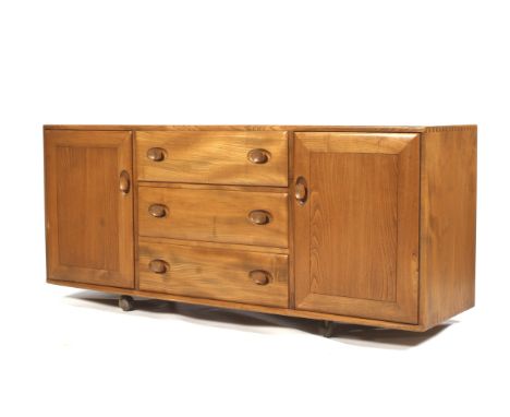 A mid-century light oak Ercol (blue &amp; gold label) mobile sideboard. With three drawers centre section flanked either side