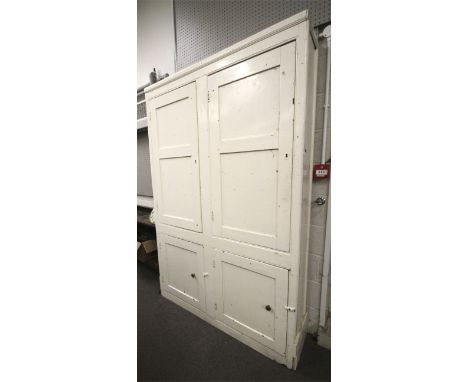 A vintage white painted pine 'Livery' cupboard. With four panelled doors. L140cm x D34cm x H212cm Condition Report: Very 'rus