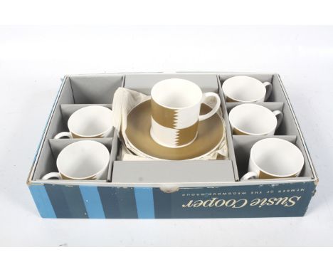 A vintage Susie Cooper 'Heraldry-Old-Gold' coffee set. In the original box