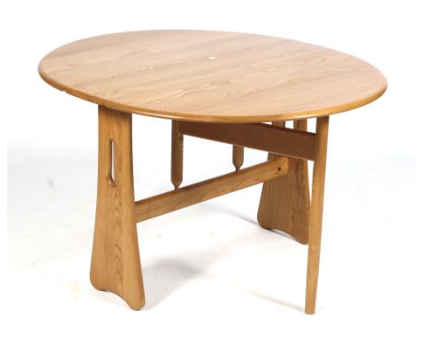 A mid-century Ercol light oak oval gateleg dining table. Size open L122cm x D107cm x H73cm 