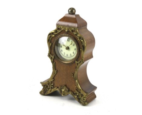 A small mahogany mantel clock. H18cm Condition Report: Appears in a fair condition, some light surface marks. Does wind up an