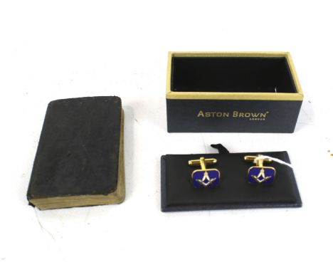 A Masonic handbook and a boxed pair of Aston Brown cufflinks. The handbook with a leather binding, the cufflinks with enamel 