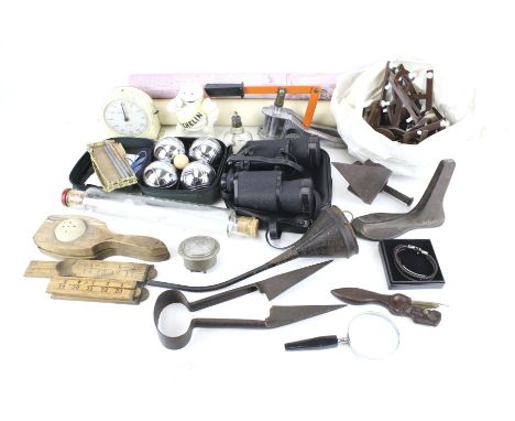 An assortment of collectables. Including a pair of binoculars, a Michelin man figure, a vintage timer clock, bowls set, etc.