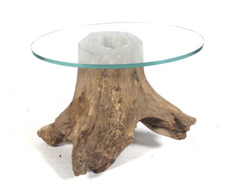 A natural tree trunk and glass top oval coffee table. L70cm x D50cm x H54cm